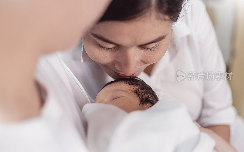 Closeup portrait of beautiful young asian mother day kissing her newborn baby. Healthcare and medical Indian hispanic family love lifestyle asia motherâs day parenthood concept panoramic banner